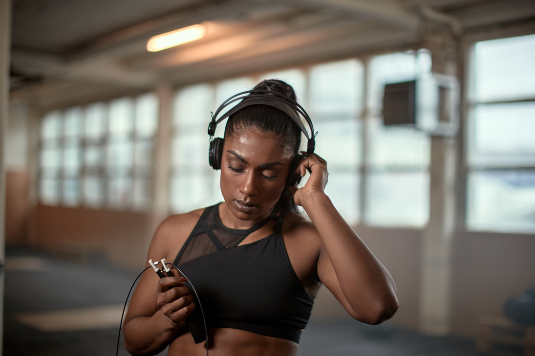 Woman Listening to Music on Headphones While Exercising